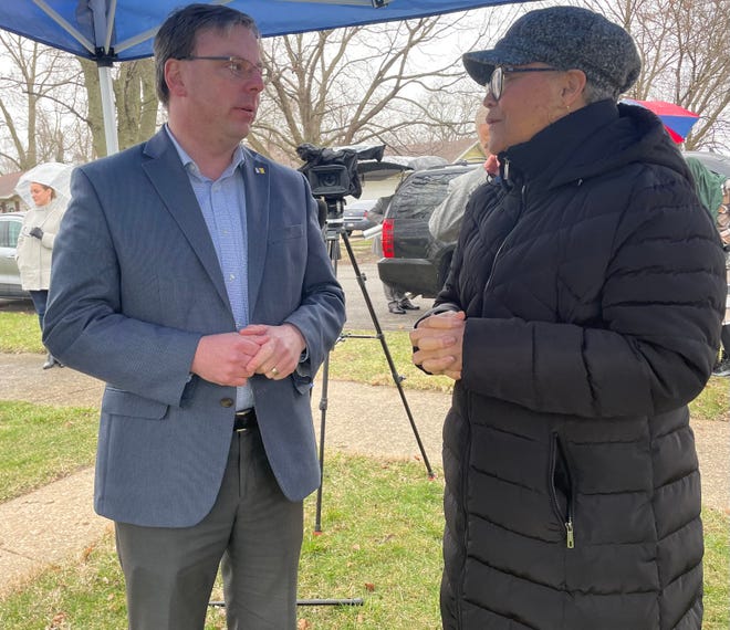 Karen Turner talks with South Bend Mayor James Mueller on Thursday about repairs needed at her home on North Chicago Street. More than $200,000 of renovations will be made to homes in Turner's neighborhood.