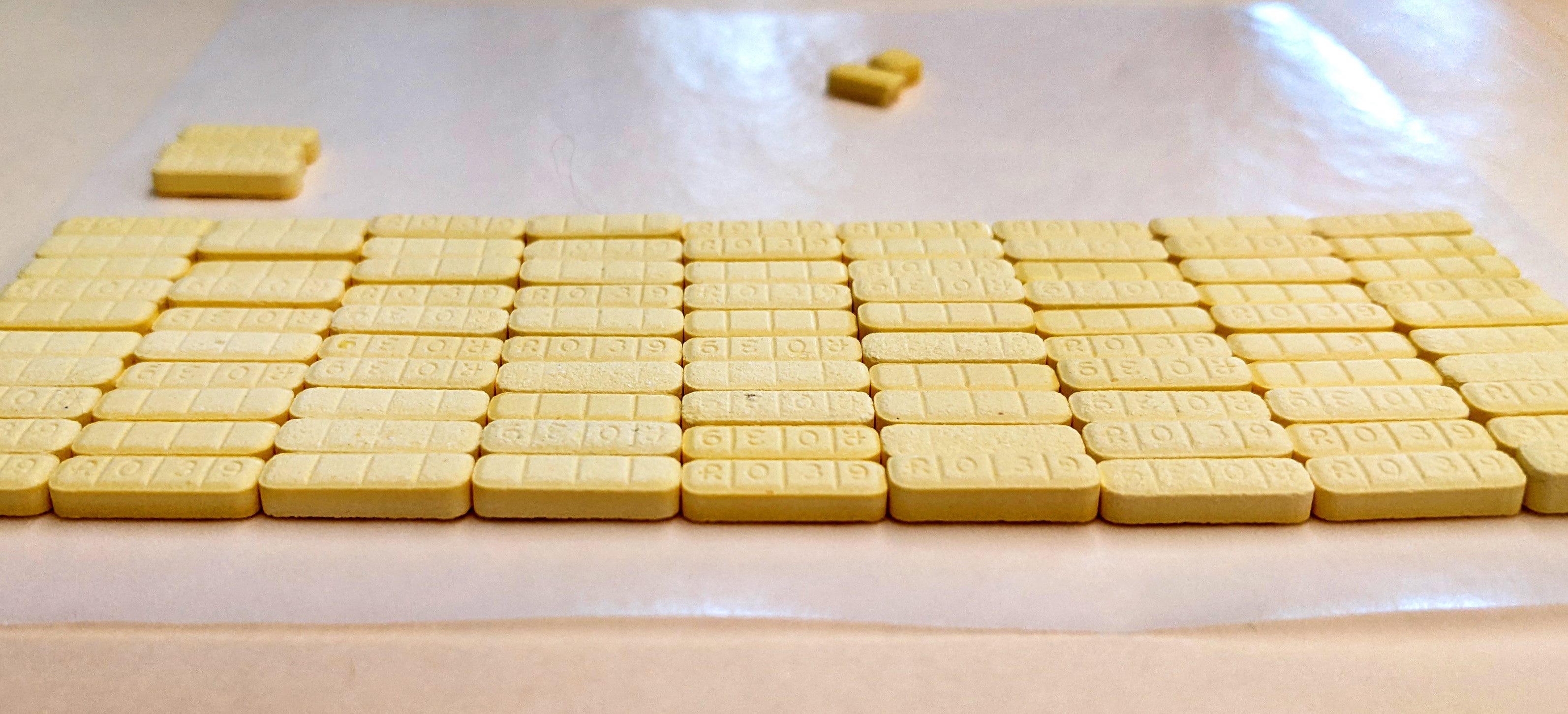 A photo taken by Laura Kimble, senior drug chemist and forensic scientist with the Hamilton County Coroner's Crime Laboratory, shows what was sold on the street as Xanax, but actually contained the street drugs clonazolam and bromazolam. Kimble pointed out the difference in the size of the pills, which were confiscated in a drug bust.