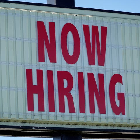 MIAMI, FLORIDA - DECEMBER 03:  A Now Hiring sign h