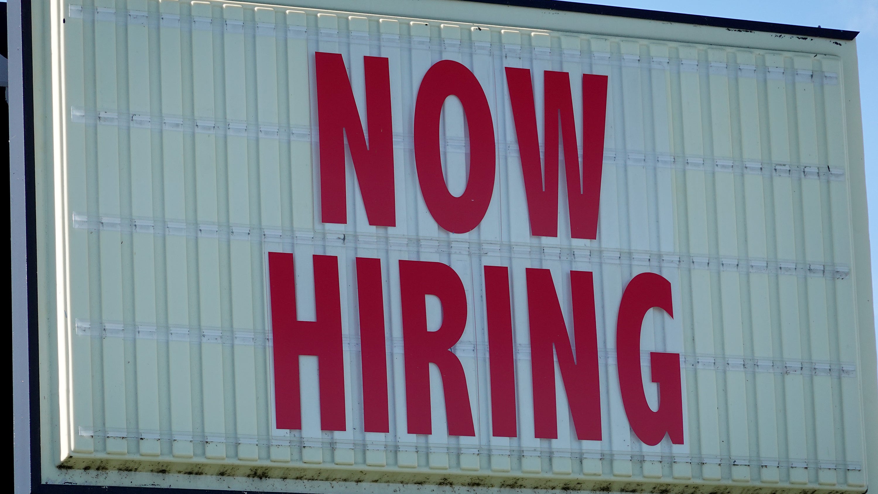 MIAMI, FLORIDA - DECEMBER 03:  A Now Hiring sign hangs in front of a Winn-Dixie grocery store on December 03, 2021 in Miami, Florida.  The Labor Department announced that payrolls increased by just 210,000 for November, which is below what economists expected, though the unemployment rate fell to 4.2% from 4.6%.  (Photo by Joe Raedle/Getty Images)