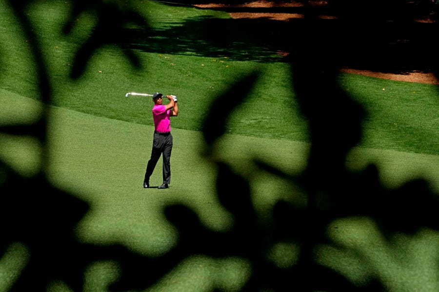 Tiger Woods plays from the fairway on the 10th hole during the first round of the Masters.