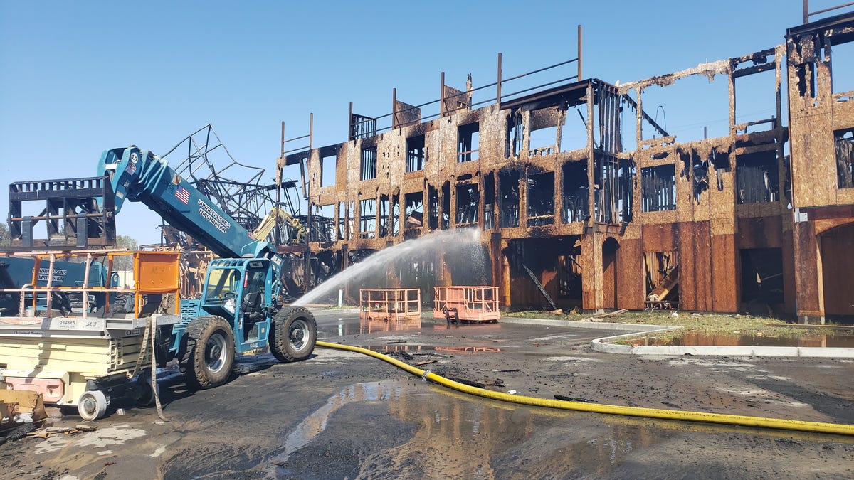 Firefighters on Wednesday continued to blast water onto the remains of a hotel under construction in Camarillo after it caught fire Tuesday night.