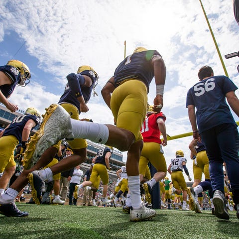 Players run onto the field during the Notre Dame B