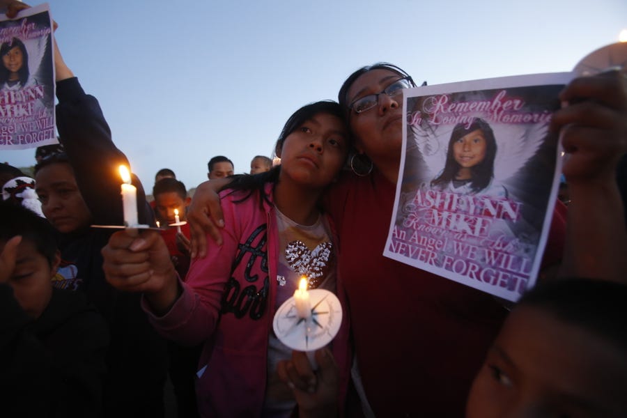 Klandre Willie, left, and her mother, Jaycelyn Blackie, of Aztec, New Mexico participate in a candlelight vigil on May 3, 2016 for Ashlynne Mike at the San Juan Chapter house in Lower Fruitland, New Mexico.