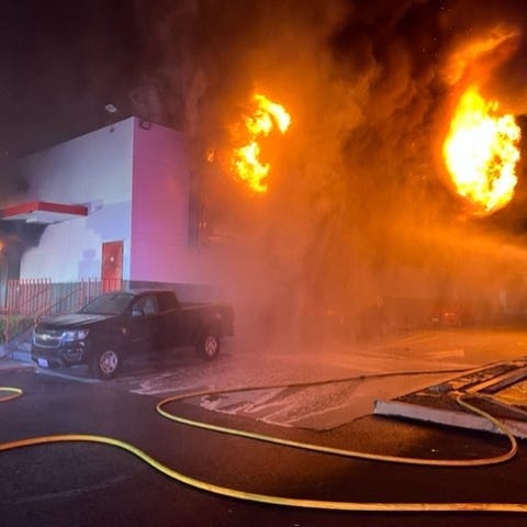 Flames leap from the interior of an AutoZone on Ea