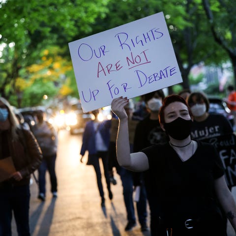 Abortion rights advocates protest outside the home