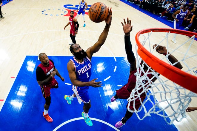 The Sixers' James Harden goes up for a shot in front of the Heat's P.J. Tucker in Game 6 of the teams' playoff series.