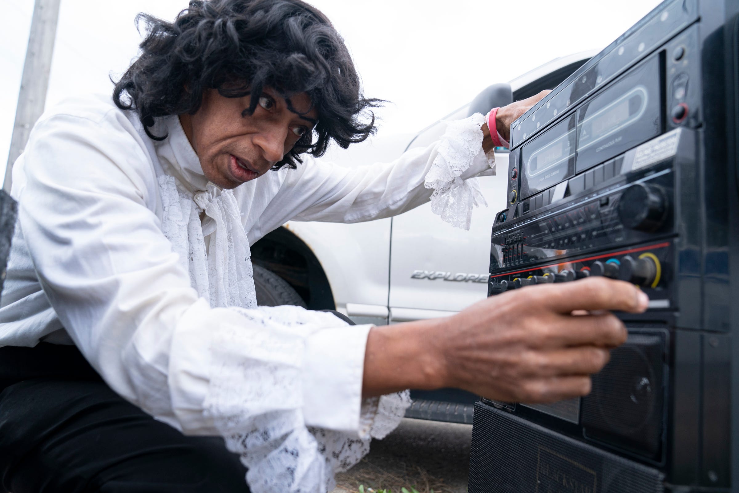 Michael Jackson impersonator Calvin Nelson, 65, of Detroit, prepares his boombox before he impersonates the late artist by playing his music and performing Michael Jackson's signature dance moves at the corner of Eight Mile Road and Sorrento Avenue in Detroit Saturday, Oct. 16, 2021.