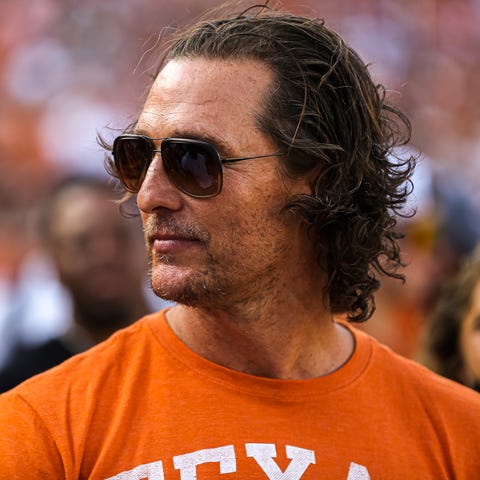 Matthew McConaughey stands on the sideline before 