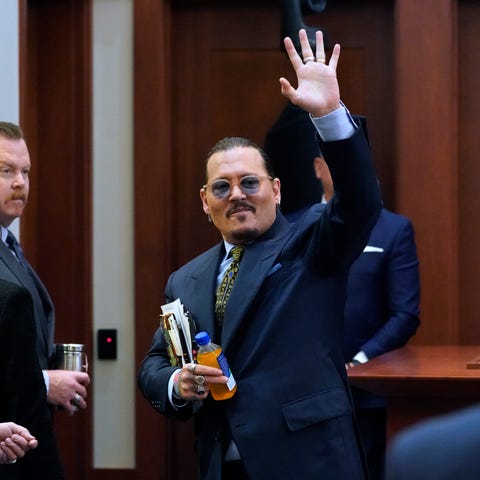 Actor Johnny Depp waves to the gallery as he leave