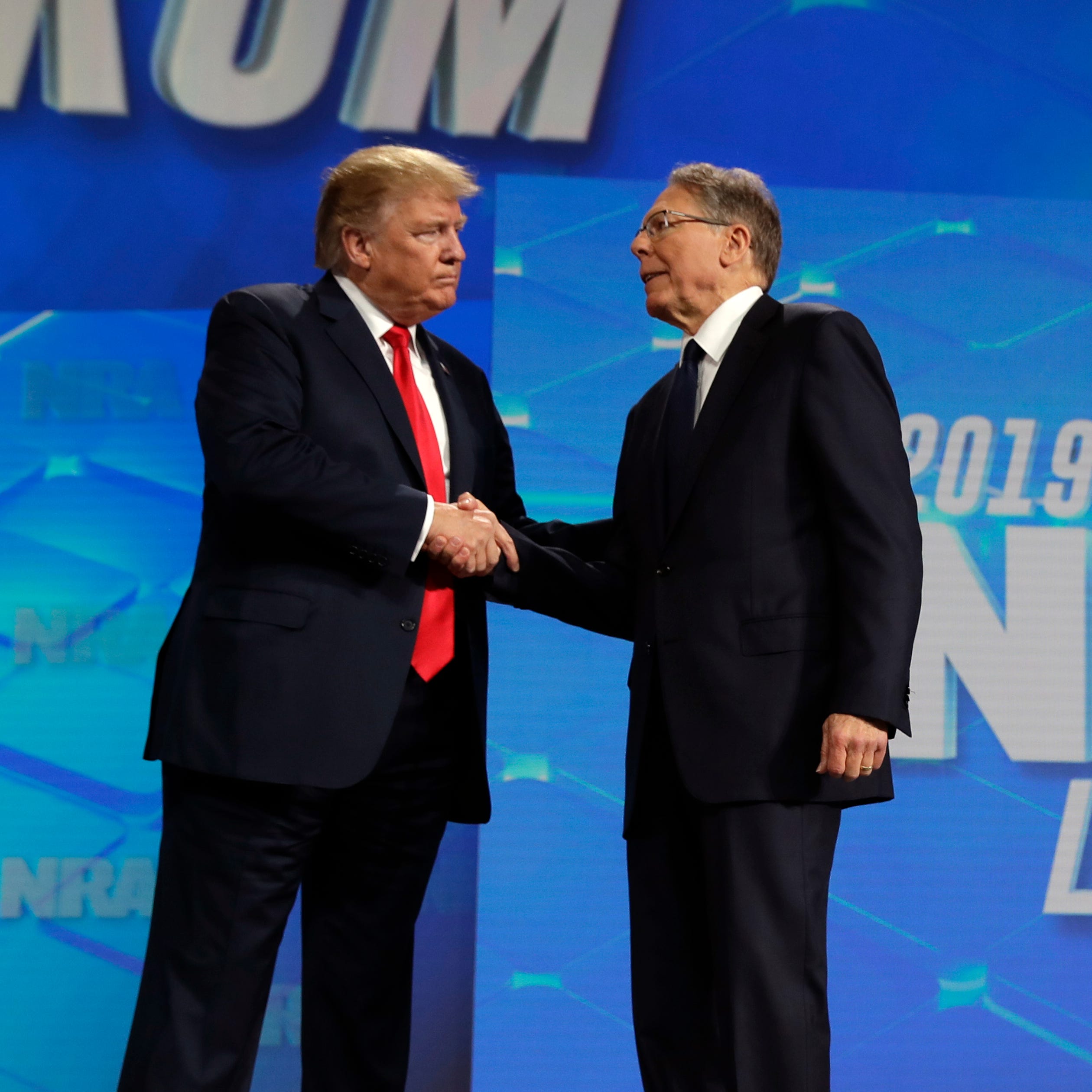 President Donald Trump shakes hands with NRA executive vice president and CEO Wayne LaPierre, has he arrives to speak to the annual meeting of the National Rifle Association, Friday, April 26, 2019, in Indianapolis. The National Rifle Association is going ahead with its annual meeting in Houston just days after the shooting massacre at a Texas elementary school that left 19 children and 2 teachers dead.