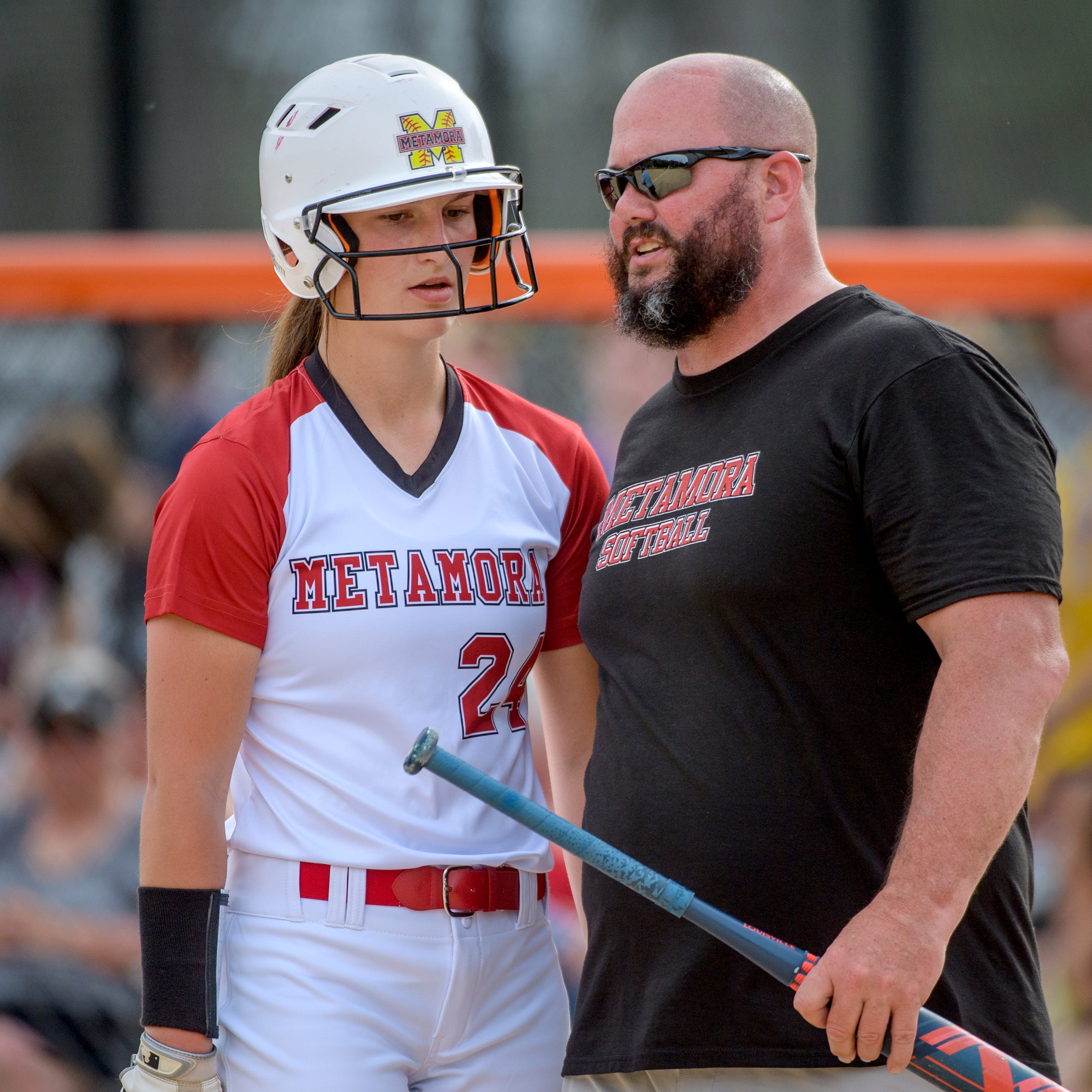 Metamora head coach Deric Linder, right, talks with Katy Ramage during an at-bat in the Class 3A softball sectional semifinals Tuesday, May 31, 2022 at Jan Smith Field in Washington. The Redbirds defeated the Bloomington Purple Raiders 7-1 to advance to the sectional title game against East Peoria at 4:30 p.m. Friday in Washington.