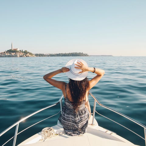 Young woman enjoys the boatride in the Adriatic se