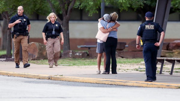 Two people hug outside at Memorial High School whe