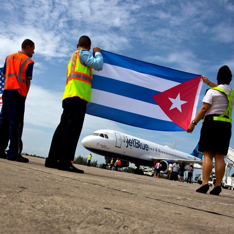 Airport workers receive JetBlue flight 387, the fi