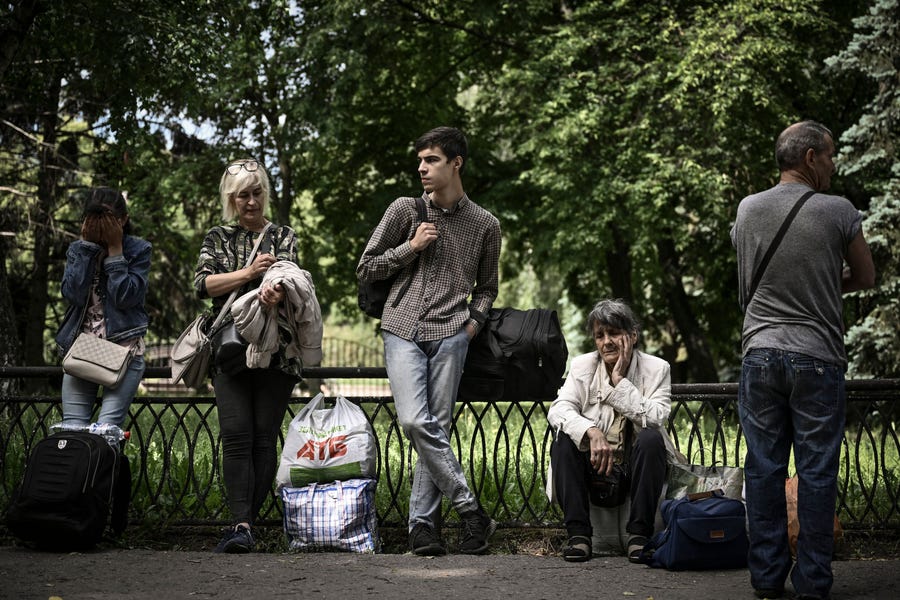 Residents wait as they evacuate the city of Sloviansk in the eastern Ukrainian region of Donbas on June 2, 2022.