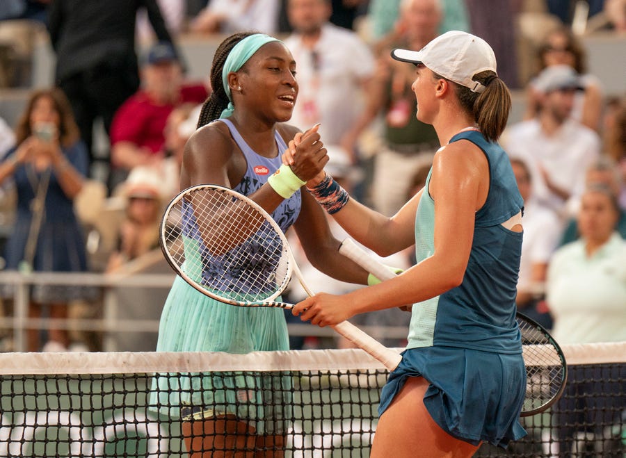 Iga Swiatek (POL) and Coco Gauff (USA) at the net after their women's final.