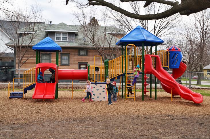 Youngsters play on the playground at the Ames Community Preschool Center.