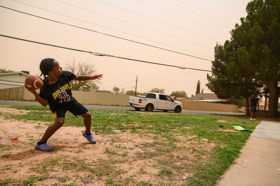 Chrisstavion Reese, 7, plays catch with his uncle Jay'shin Williams in the midst of a dust storm Wednesday, June 8, 2022 in Odessa, Texas.