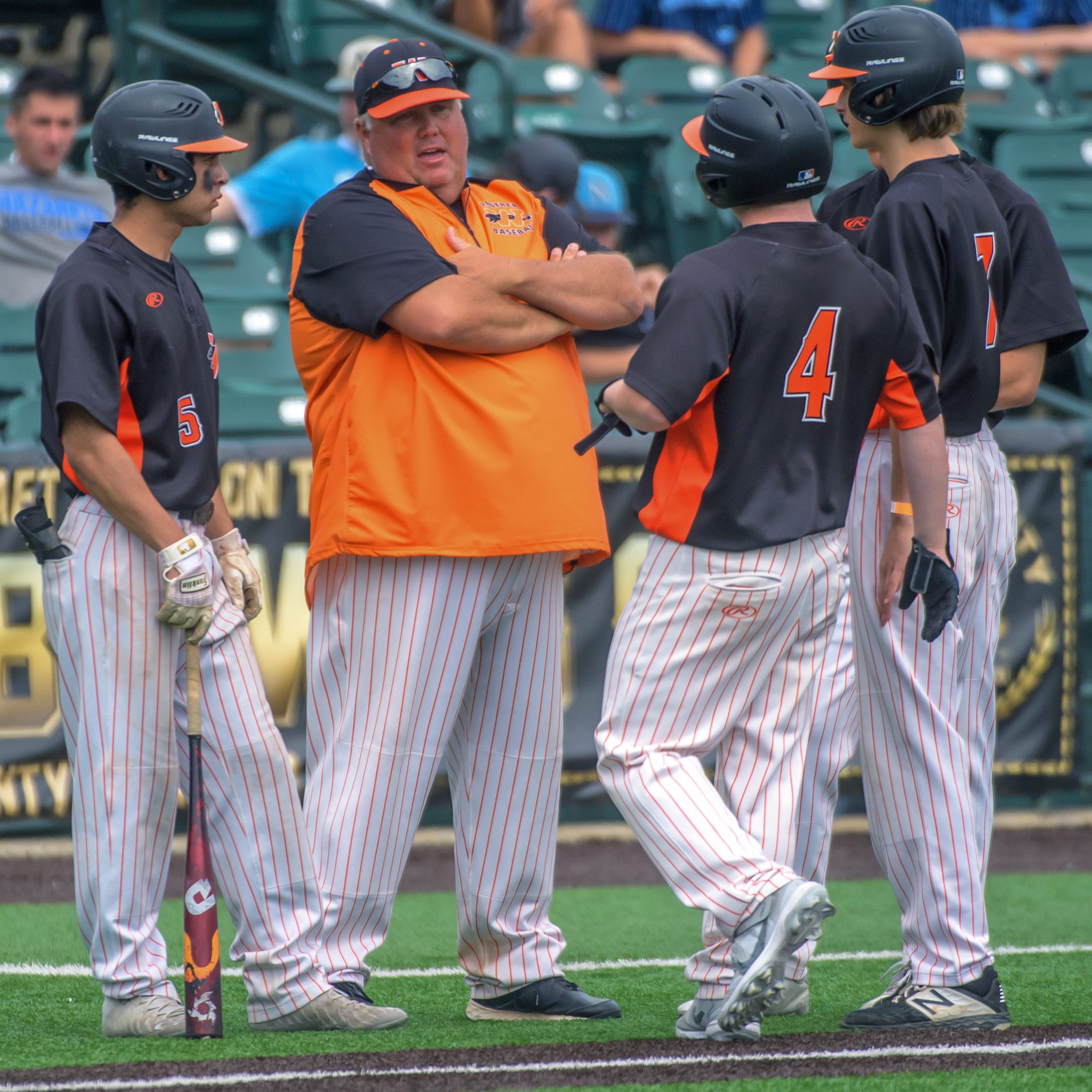 Washington head coach Kyle Wisher talks to some of his players during a break in the action against Crystal Lake South in the Class 3A state baseball third-place game Saturday, June 11, 2022 at Duly Health & Care Field in Joliet.