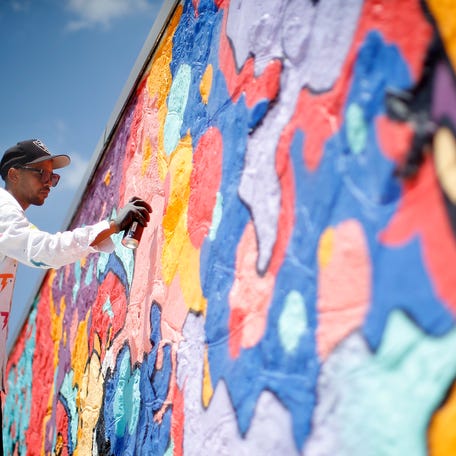 Tony Thunder works on a mural during Juneteenth on East in Oklahoma City, Saturday, June, 18, 2022. 