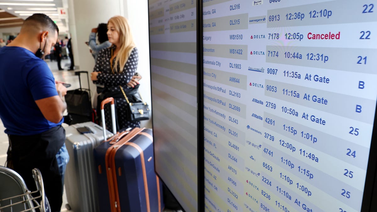 Travelers gather in the Delta terminal at Los Angeles International Airport on June 30. Flight cancellations and delays increased before the busy Fourth of July travel weekend amid airline staffing shortages.