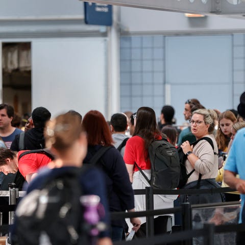 Travelers wait in line at O'Hare International Air