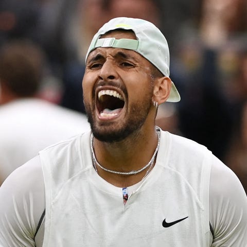 Nick Kyrgios celebrates after beating Stefanos Tsi