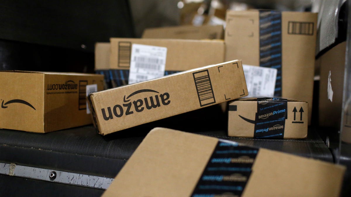 In this Nov. 20, 2015, file photo, packages being shipped in Amazon boxes ride a conveyor belt at the UPS Worldport hub in Louisville, Ky.