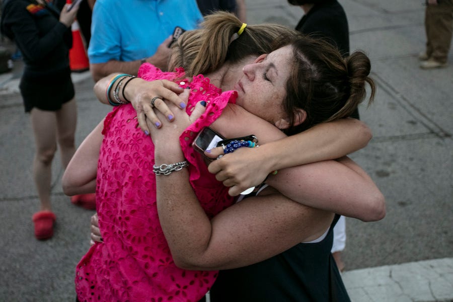 Hillary Heller, Shannon Rowe and Lucy Heller embrace near the scene of a mass shooting yesterday at a Fourth of July parade, on July 5, 2022 in Highland Park, Illinois. Authorities have charged Robert 