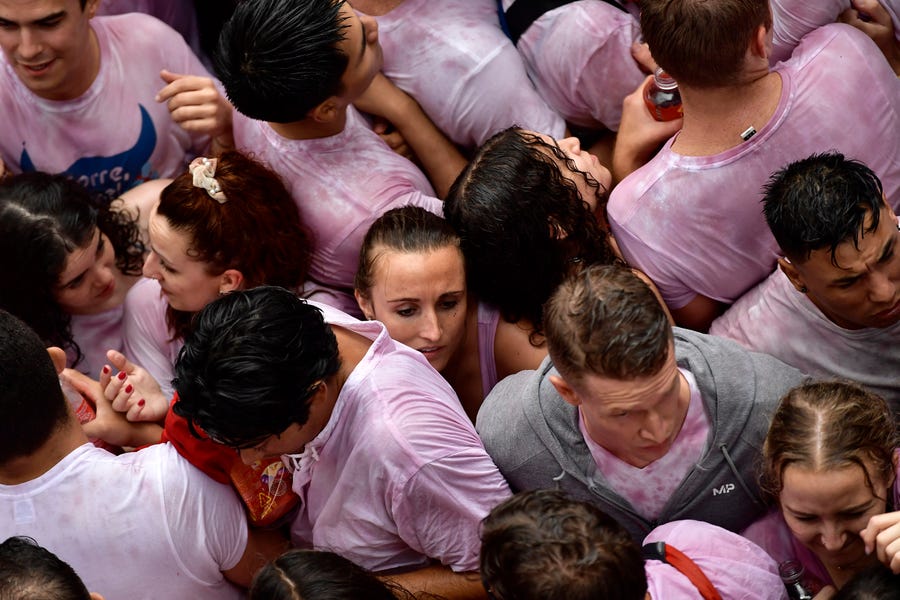 Revelers fill the town hall square celebrating the launch of the 'Chupinazo' rocket, to mark the official opening of the 2022 San Fermin fiestas in Pamplona, Spain, Wednesday, July 6, 2022. The blast of a traditional firework opened Wednesday nine days of uninterrupted partying in Pamplona's famed running-of-the-bulls festival which was suspended for the past two years because of the coronavirus pandemic.