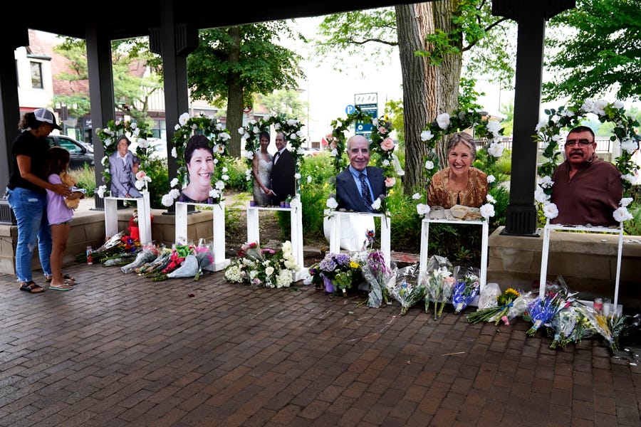 Visitors pay their respects at altars for the seven people killed in Monday's Fourth of July mass shooting, Thursday, July 7, 2022, in Highland Park, Illinois.