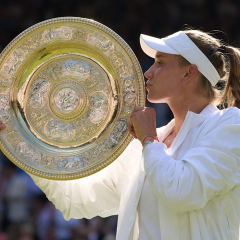 Elena Rybakina kisses the trophy after winning the