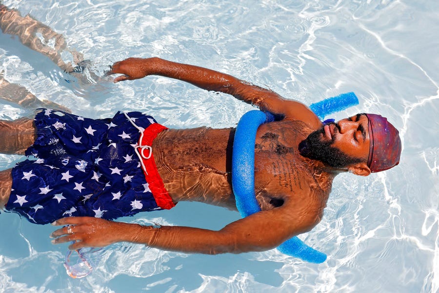 Yonny Hodges floats in the Lacy Park Pool, Friday, July 8, 2022 in Tulsa, Okla. It is the 5th day in a row for temperatures of 100 degrees Fahrenheit or more, the first time since July 2012.