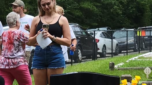 Rachel Tuten, a friend of the late Stephen Smith, reacts emotionally during Sunday's memorial unveiling.