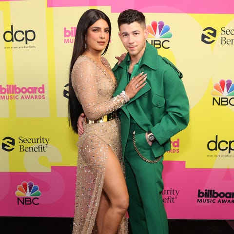 Priyanka Chopra, left, and husband Nick Jonas pose