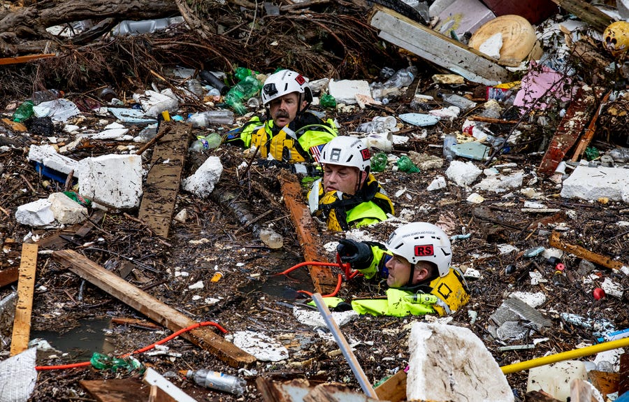 Members of the Tennessee Task Force One search and rescue team searched through Troublesome Creek in Perry County, looking for potential victims after one of the Gideon Rescue HR (Human Remains) Dogs 'hit' on an area jumbled with debris on Sunday, July 31, 2022