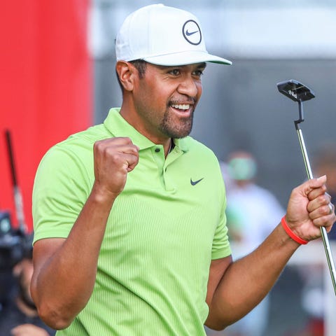 Tony Finau celebrates on the 18th green after winn