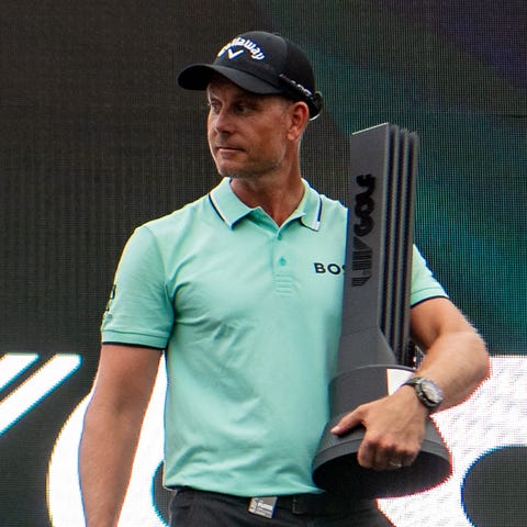 Henrik Stenson holds the championship trophy after