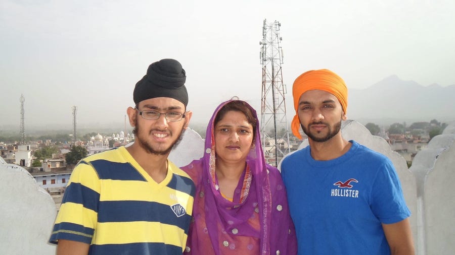 Harpreet Singh Saini, left, with his mother, Paramjit Kaur Saini, and his brother, Kamal Singh Saini.