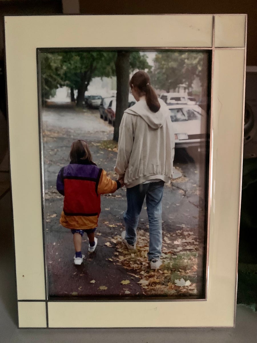 Connie Schultz's son Andy holds his sister Caitlin's hand during parents weekend of his freshman year in college. Years later, Schultz keeps the framed photo of the moment on her desk.