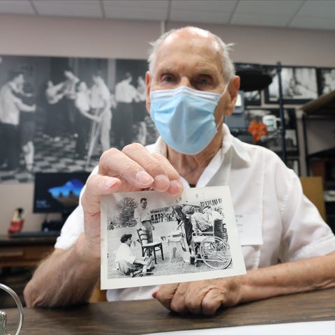 Elwood Ennis, 87, of Bardonia holds a photo from 1