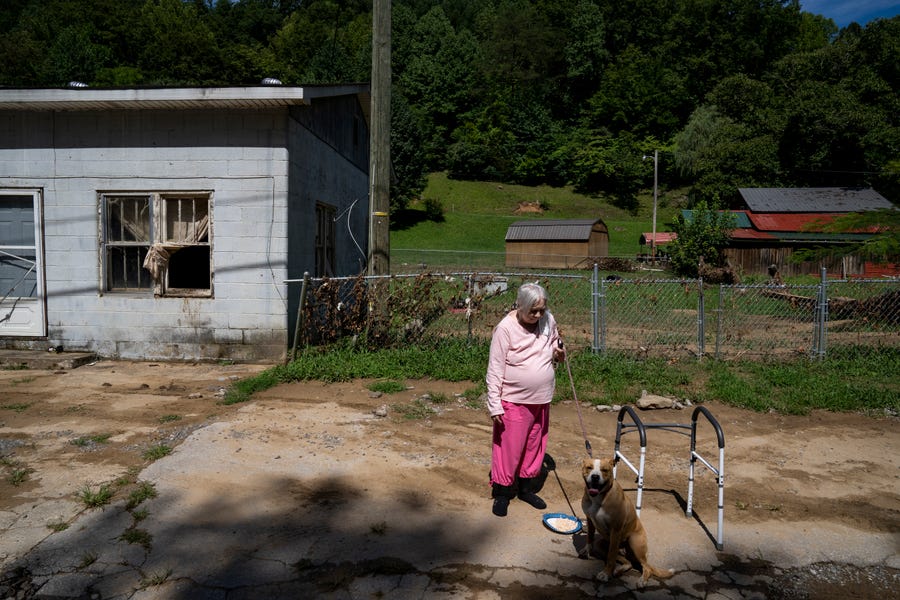 Linda Engle Chaffins, 70, waits for a FEMA representative next to the highway in Perry County, Kentucky near Hazard on August 6, 2022. Thousands of Eastern Kentucky residents have lost their homes ater devastating rain storms have flooded the area over the past week.