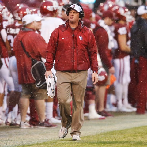 Oklahoma assistant coach coach Cale Gundy walks on