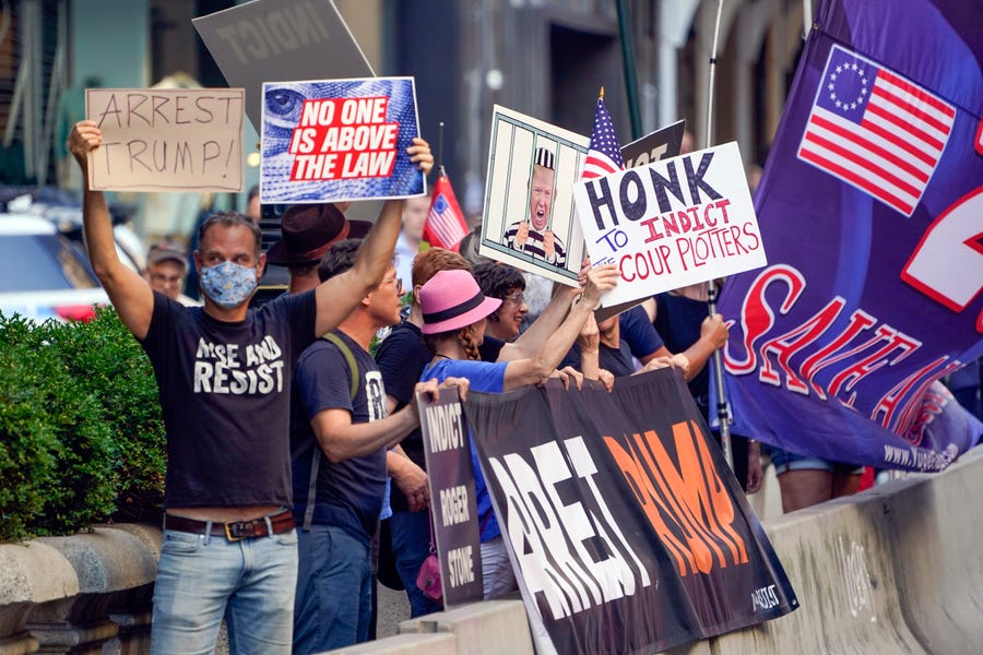 Protesters stand in front of Trump Tower in New York, Tuesday, Aug. 9, 2022.