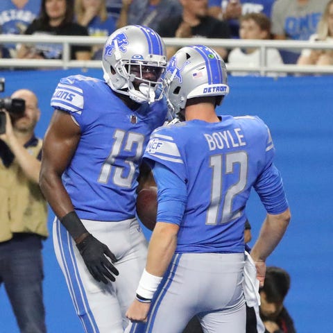 Lions tight end Devin Funchess, left, celebrates h