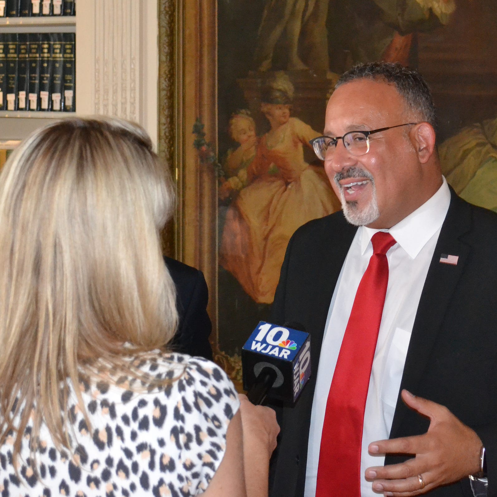 U.S. Secretary of Education Dr. Miguel Cardona speaks to a reporter after a celebration of the 50th anniversary of the Pell Grant Monday at Salve Regina University.