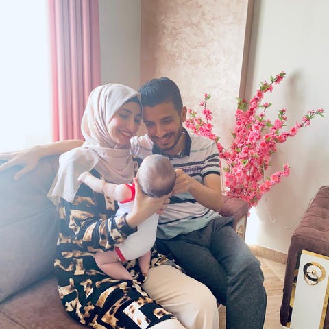 Issam Adwan and his wife hold their baby, Sara, in