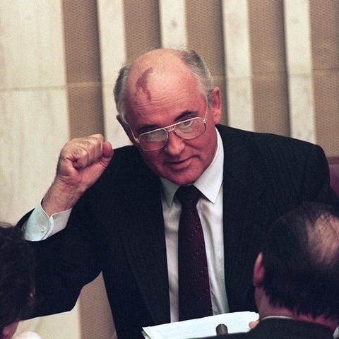 Soviet President Mikhail Gorbachev raises a clench