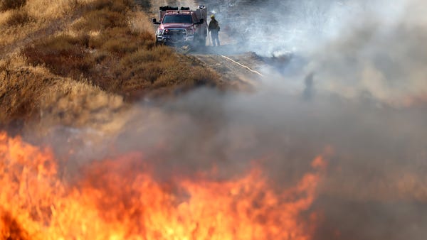 A firefighter works as the Route Fire burns on Aug